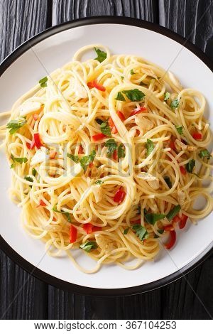Spaghetti Aglio E Olio is A Simple Italian Dish Of Garlic, Olive Oil, Parsley Close-up In A Plate. V