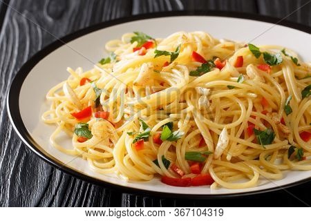 Tasty Aglio E Olio Pasta With Fried Garlic, Parsley And Hot Pepper Close-up In A Plate. Horizontal