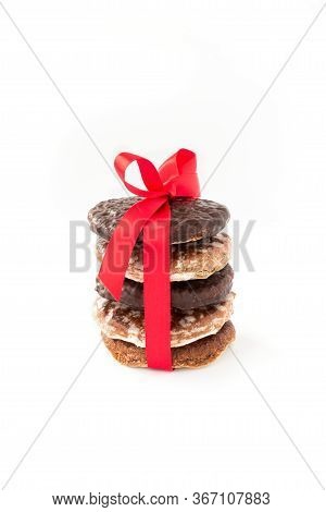 Stack Of Assorted, Original Nuremberg Lebkuchen, Gingerbread With Red Bow And Ribbon Isolated On Whi