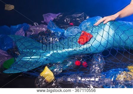 Ocean Plastic Pollution Concept. Mermaid Scared Due To Polluted Habitat. Close-up.
