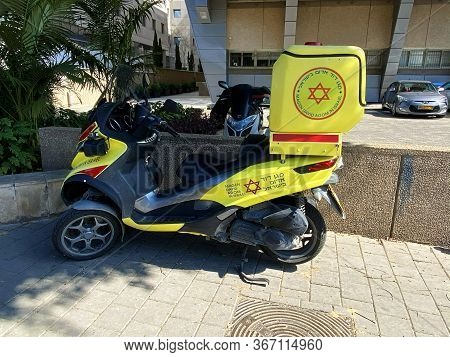 Tel Aviv, Israel - March 06, 2020: A Medicycle Special Scooter Painted Yellow With Emergency Number 