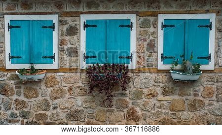 Antalya, Turkey - 7th May 2020: Three Windows On Stone Wall With Turquoise Wooden Closed Blinds And 