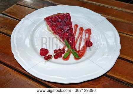 Pie With Raspberries And Red Currants On The Plate