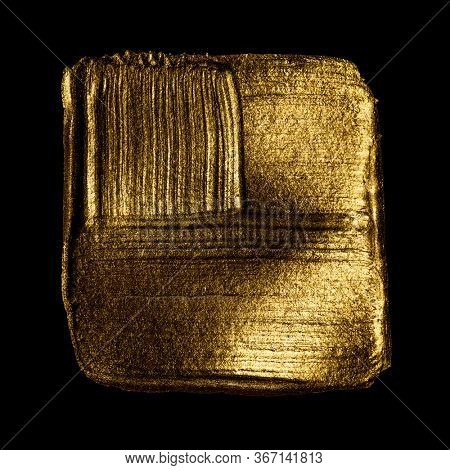 Creative brushstrokes of gold paint isolated on a black background. Gold paint texture.Acrylic gold paint. Smears of cosmetics, blush, highlighter, eye shadow, lipstick.