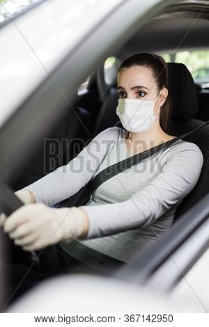 Portrait Of Woman Driver With Face Mask And Medical Gloves, Coronavirus Pandemic Concept.