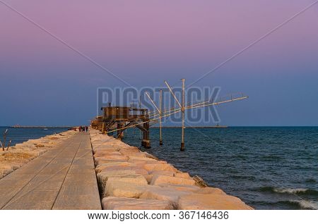 Traditional Fishing Stations Houses With Fishnet In Water Of Adriatic Sea At Pier Diga Sottomarina, 