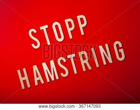 stopp hamstring norwegian word text wooden letter on red background coronavirus covid-19
