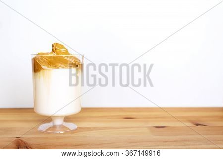 Dalgona Coffee In Glass On Wooden Table. Copy Space. Amazing Delicious Trendy Korean Whipped Drink. 
