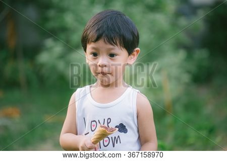 Asia Boy He Mouth Aftertaste From Eating Chocolate Ice Cream  Or Chocolate Dessert. A Sweet-toothed 