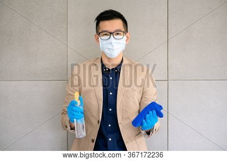 Business Woman Wearing Mask And Using Personal Sanitizer To Cleaning His Office To Keep Hygiene.prev
