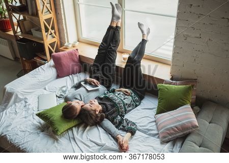 Lying Down, Lovely. Quarantine Lockdown, Stay Home Concept - Young Beautiful Caucasian Couple Enjoyi