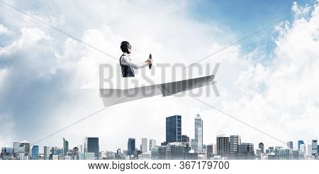 Business Motivation Concept With Pilot Sitting In Paper Airplane. Funny Man In Aviator Hat And Goggl