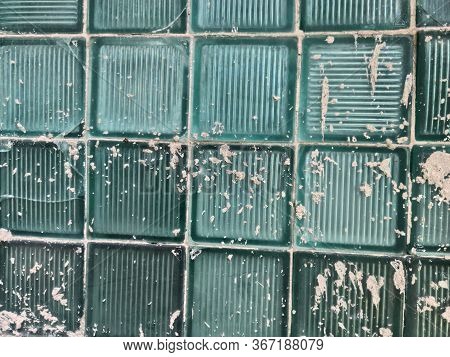 Wall Of Glass Blocks With Splashes Of Gray Cement