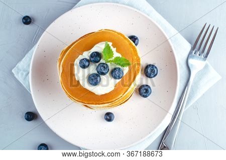 A Stack Of Pancakes With Fresh Blueberries And Cheesecream. Top View.