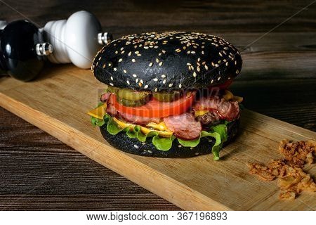 Juicy Burger Black Dark Bread, Cheese, Meat Slices Of Pork, With 
Onion Fries