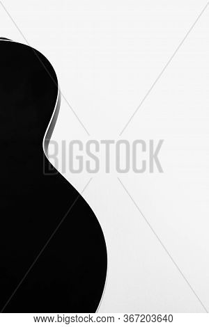 Black Electric Rock Guitar Smooth Shape Silhouette On White Wall Background.hollow Steel-stringed Ja