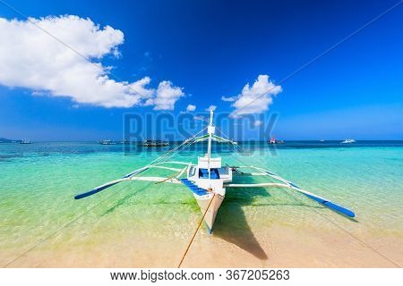 Traditional Filipino Boat At The Idyllic White Sand Beach At Boracay Island In Philiphines