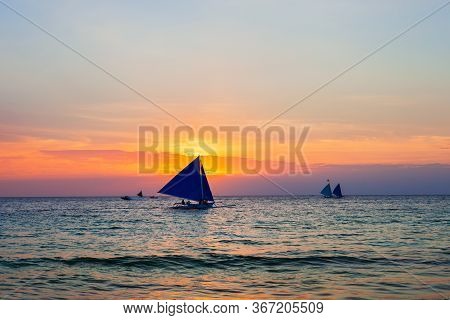 Traditional Filipino Boat At The Idyllic White Sand Beach At Boracay Island In Philiphines At Sunset