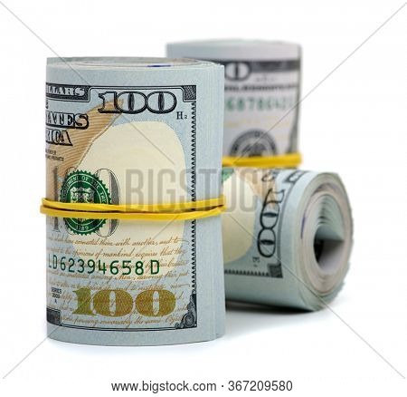 Hundred dollar bills rolled up with rubberband isolated on white background 
