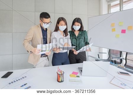 Business Employees Wearing Mask During Work In Office To Keep Hygiene Follow Company Policy.preventi
