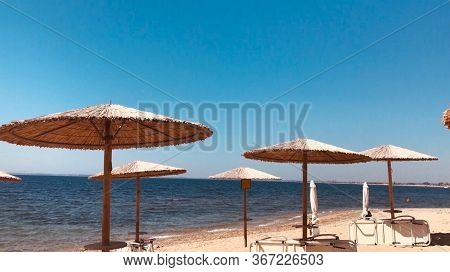 Abandoned Beach With No Perople And Locked Sunbeds Isolated With Restricted Access