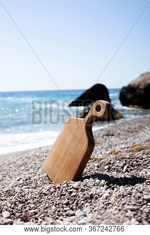 Oak Light Brown Cutting Board. Picnic With A Sea View. Plave For Your Text.
