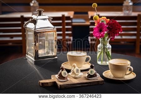 Mix Of Chocolates On A Table With Black Background, Confectioners Assortment Of Bon Bon Candies