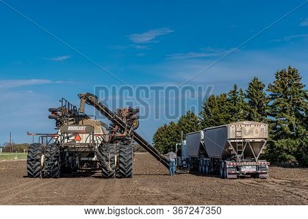 Swift Current, Sk/canada- May 15, 2020: Farmers Loading Seed And Fertilizer From The Super B Into Th