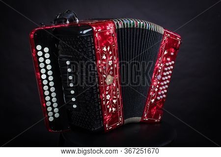 Russian Folk Instruments Red Bayan On A Black Background.russian Accordion