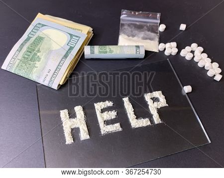 Pills, Us Dollar Banknotes And Cocaine  On A Gray Background. Stop Drugs Concept. A Word 