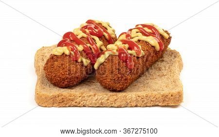 Brown Crusty Dutch Kroket With Mustard Topping Isolated, On A Piece Of Bread, On A White Background