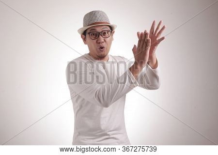 Young Asian Man Wearing White Shirt, Happy Proud Clapping Gesture.over Grey Background, Halfl Body P
