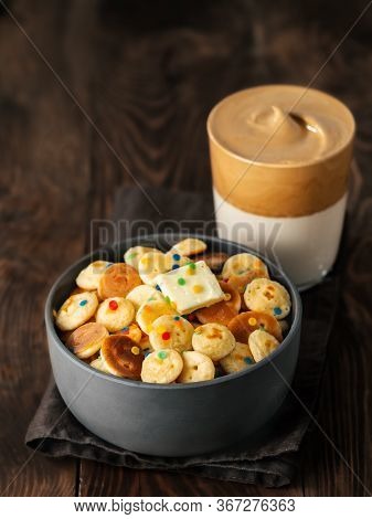 Mini Pancakes Cereal And Dalgona Coffee On Brown Wooden Background, Copy Space. Trendy Food And Drin