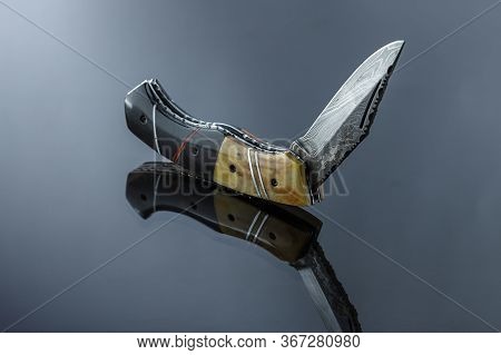 Folding Pocket Knife On A Mirrored Surface, Blade Made Of Multi-layer Damascus Steel, Handle Made Of