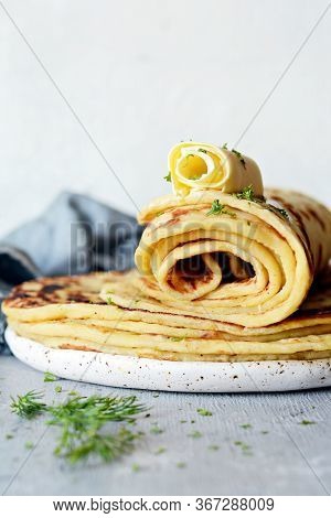 Norwegian Potato Pancakes Lefse On A Light Background With Cheese And Greens. Traditional Scandinavi