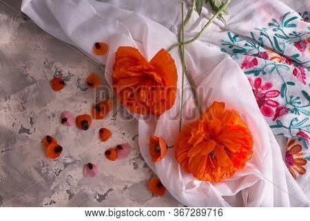 Stillife With Red Poppies On Grey Concrete Background And White Drappery.