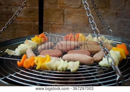 Some Barbecue Food Over A Barbecue. Kababs, Sausages And Burgers.