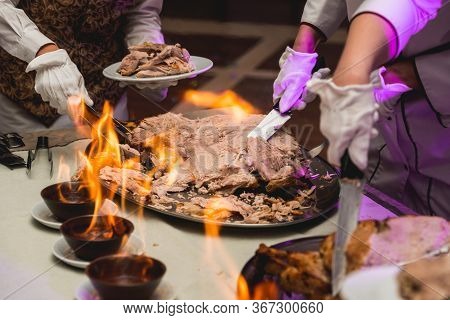 Appetizing Grilled Meat On Fire Close-up. Beautiful Presentation Of The Dishes In The Restaurant