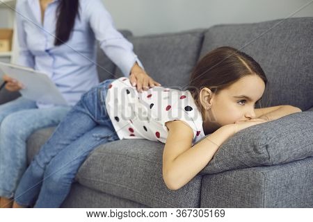 Child Psychologist Psychology. Woman Psychologist With A Clipboard Helps A Child With A Problem In T