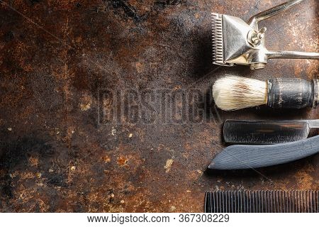 On A Rusty Surface Are Old Hairdresser Tools. Manual Clipper, Comb, Razor, Shaving Brush. Rustic. Ho