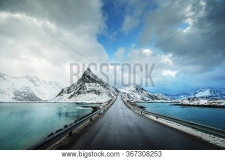 Olstind Mount and asphalt road. Lofoten islands, spring time, Norway