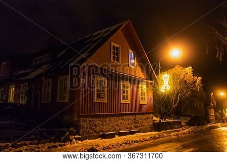 Trakai, Lithuania - December 26, 2018: Night View Of Old Residential Wooden House At Winter Time In 
