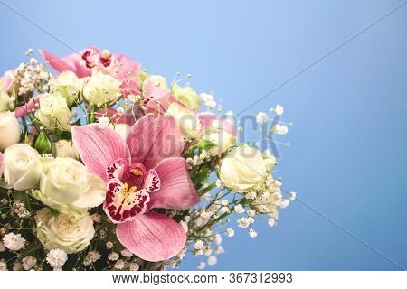 Close Up Of Beautiful Bouquet Of Orchids, Roses And Gypsophila, Babys-breath Flowers In Decorative P