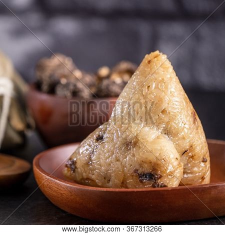 Rice Dumpling, Zongzi - Chinese Rice Dumpling Zongzi On Black Brick Background Slate Table, Concept
