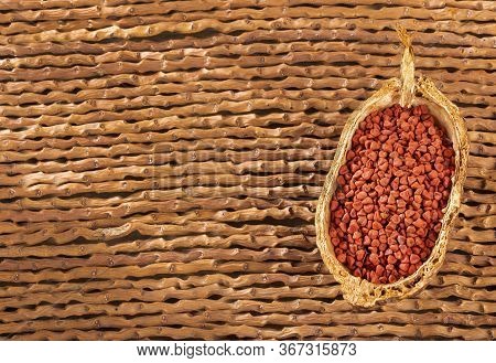 Organic Achiote Seeds - Bixa Orellana. Wood Background