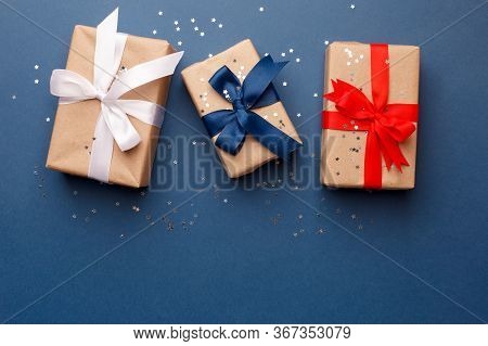 Red, Blue And White Gift Boxes On Classic Blue Background In The National Colors Of America, Russia,