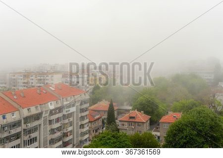 Residential Lowrise Houses And Streets With Green Trees In Dense Fog At Summer Day. Thick Fog Came F