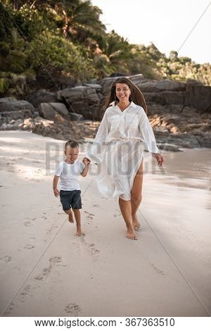 Happy Smile European Family Have Rest And Run On White Sand Beach