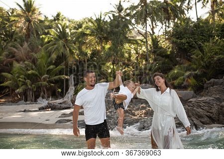 Happy Smile European Family Have Rest And Run On White Sand Beach