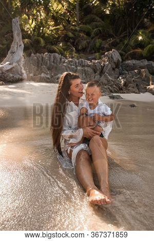 Happy Smile European Family Have Rest And Run On White Sand Beach